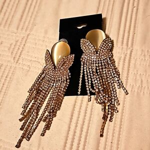 Rhinestone earrings in goldtone setting.